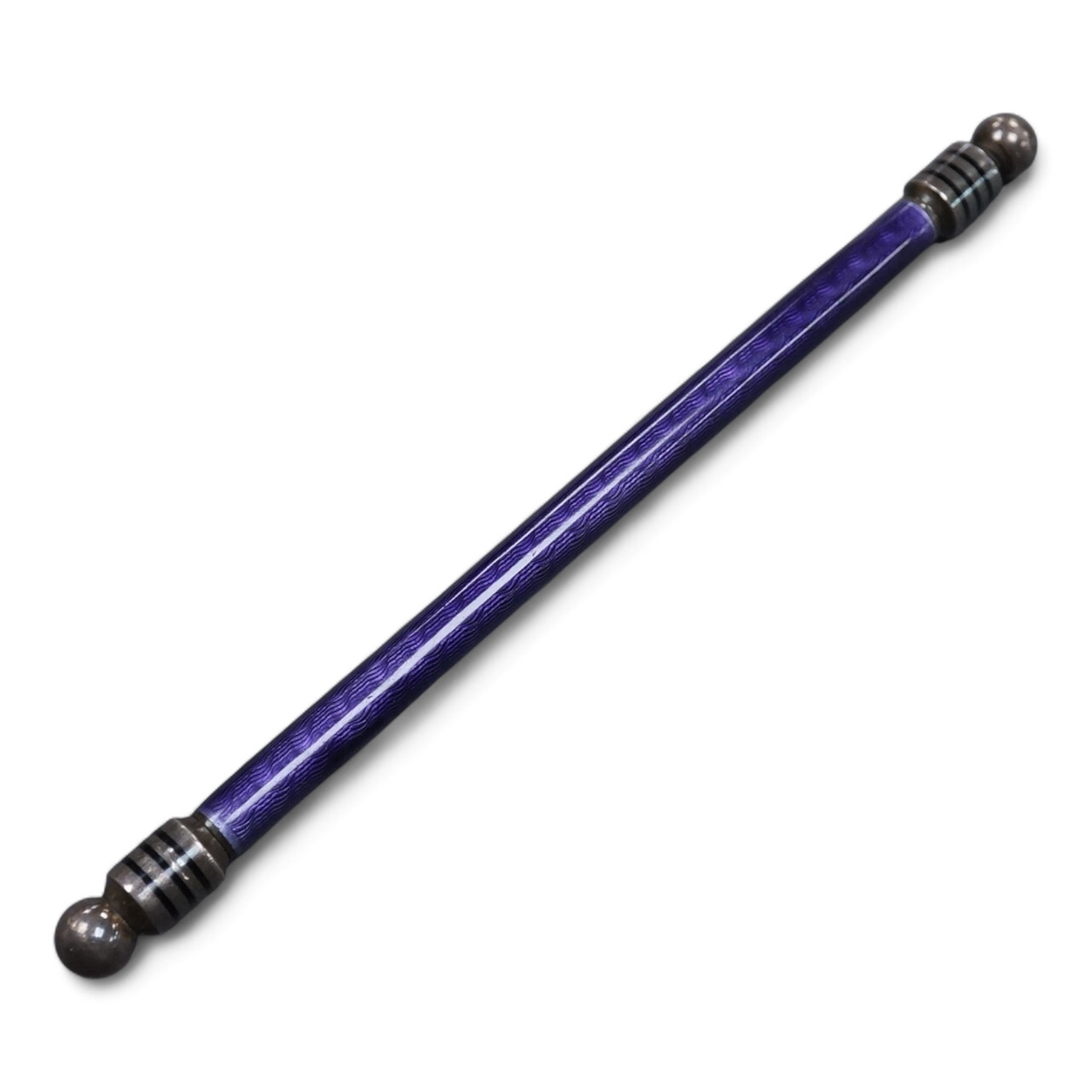 A silver and purple guilloche enamel pen, with ringed black enamel and globe terminals, one unscrews to reveal the pen tip, hallmarks beneath the enamel, possibly London, 1979, 13.9cm.